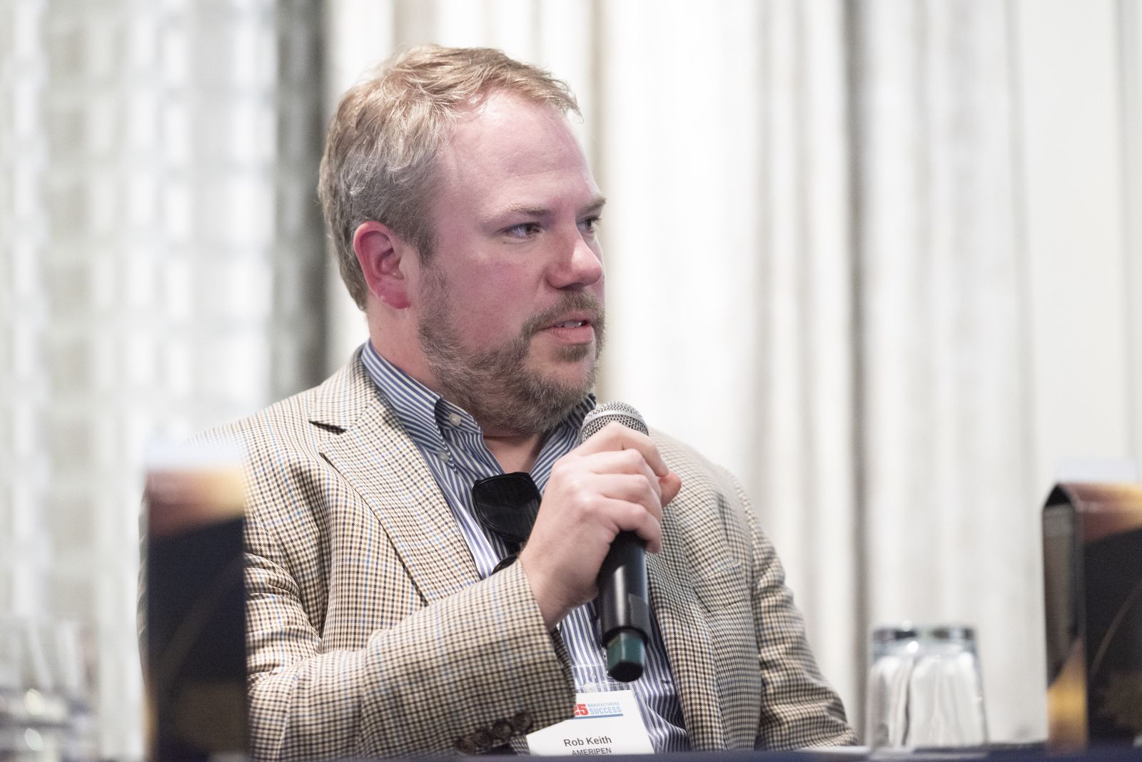 Rob Keith speaking into microphone